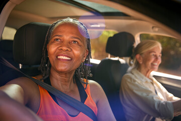 Fototapeta na wymiar Two Senior Female Friends Enjoying Day Trip Out Driving In Car Together