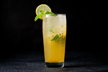 Refreshing cocktail Mojito in a glass with passion fruit