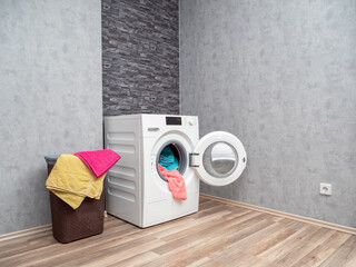 Laundry room interior with washing machine against the wall. Modern washing machine.