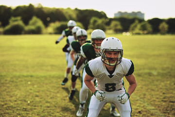 American football team practicing outdoors
