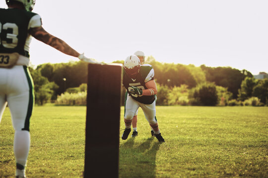 American football players practicing tackles during a team practice