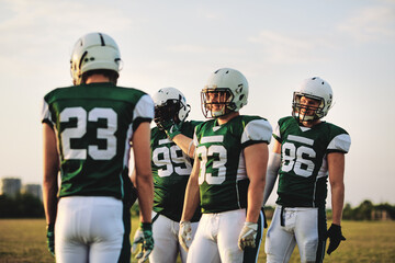 American football team talking during practice