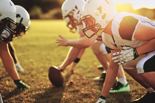 Football teams scrimmaging on a field