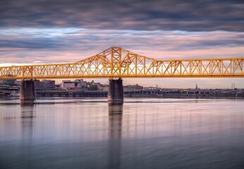 Long exposure shot of the yellow Second street bridge at sunset in Louisville, Kentucky.
