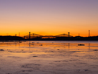 The 1970 Pierre-Laporte and the 1904 Quebec bridges over the St. Lawrence river in silhouette before sunrise, Cap-Rouge area, Quebec City, Quebec, Canada