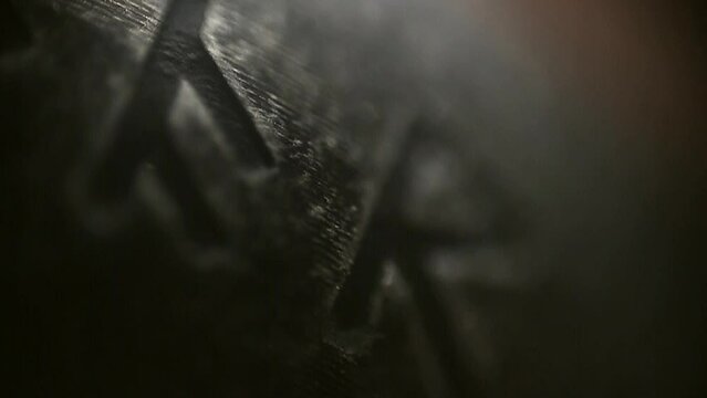 The texture of the engraved runes on a black ring in a close-up macro video