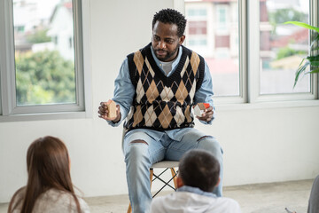 African American teacher teaching about family to students in class at school. Kid sitting and listening to black man. Learning and education concept	