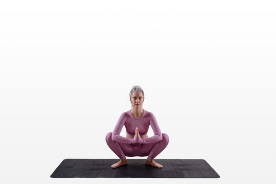 Woman practicing yoga - Malasana - garland pose