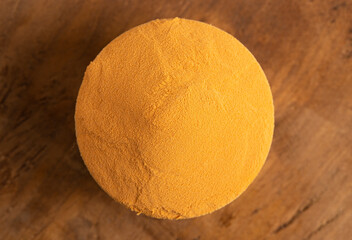 Bowl of Goji Berry Powder a Superfood Ingredient Great in Smoothies on a Wooden Table