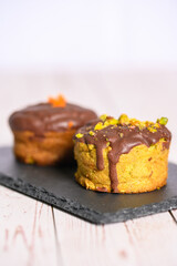 Two muffins on a slate plate