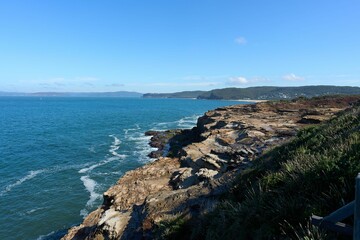 Fototapeta na wymiar Aerial seascape with coastal rocky cliffs on a sunny day