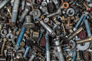 Background of bolts and nuts of different lengths and threads. Industry and production.