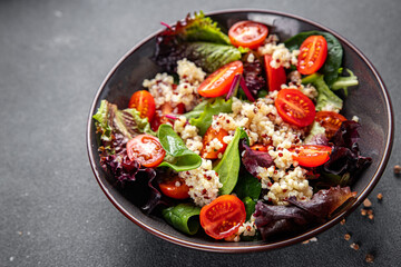 quinoa salad tomato, green leaf mix healthy meal food snack on the table copy space food background rustic top view 