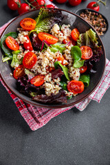 quinoa salad tomato, green leaf mix healthy meal food snack on the table copy space food background rustic top view 