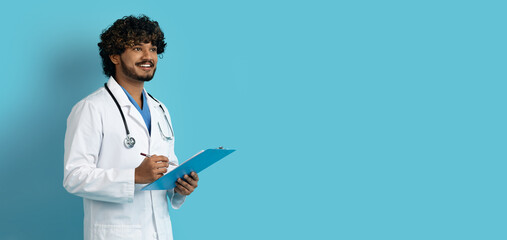 Handsome indian doctor with medical chart looking at copy space