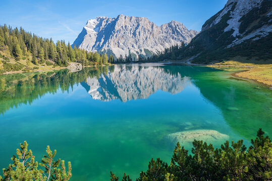 turquoise lake Seebensee and Zugspitze mountain, reflecting in the water