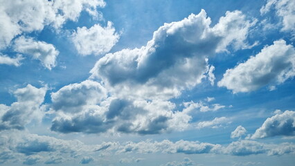 White cloudy swimming under blue sky.