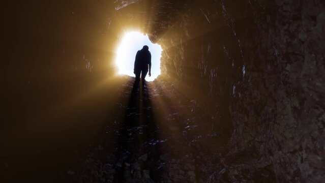 Woman walks in a stone tunnel with rays