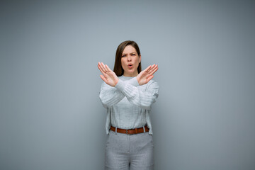 Woman gesturing stop with crossed hands. isolated female portrait.