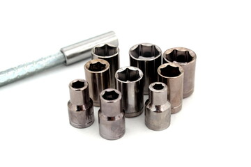 Screwdriver with bits for tightening bolts lie on a white background.	