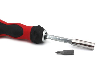 A screwdriver with a removable tip lies on a white isolated background.	