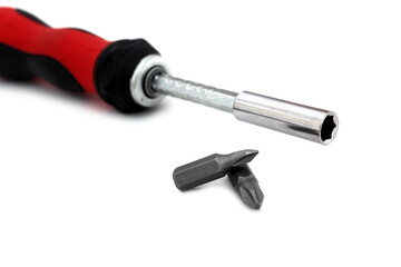 A screwdriver with a removable tip lies on a white isolated background.	