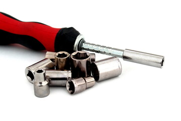 Screwdriver with bits for tightening bolts lie on a white background.
