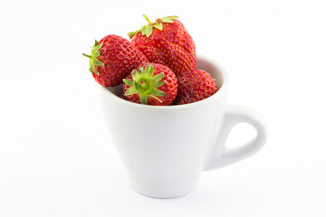 Ripe red strawberries in a cup on a white background