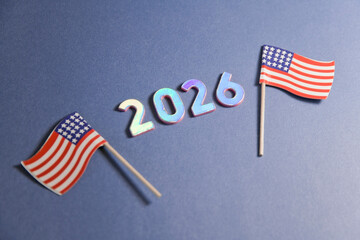 2026 Metallic Numbers with Mini American Flags on Blue Background - obrazy, fototapety, plakaty