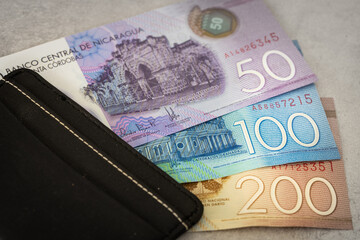 Nicaragua money, various banknotes, black stylish wallet, close up, Nicaraguan Cordobas currency