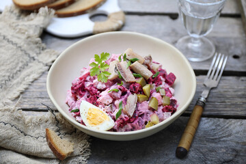 Heringsalat. Beetroot salad with herring, parsley and egg dressing