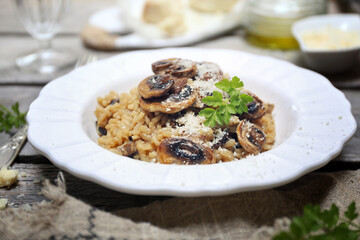 Italian food. Mushroom risotto, olive oil and grated parmesan cheese gressing