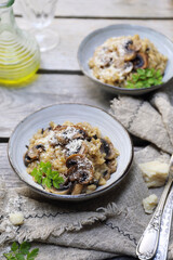 Italian food. Mushroom risotto, olive oil and grated parmesan cheese gressing, two portions