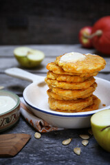 Stack of apple pumpkin pancakes with sour cream