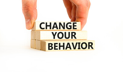 Motivation and Change your behavior symbol. Concept words Change your behavior on wooden block on a beautiful white table white background. Business change your behavior concept. Copy space.