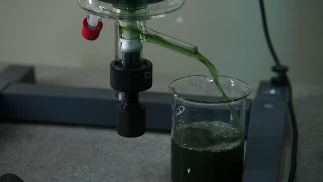 Chemical process. Stock footage. Working with green chemical elements that are poured into different test tubes.