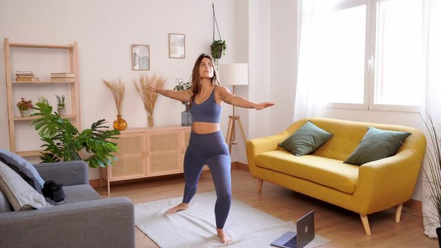 Woman practicing yoga at home