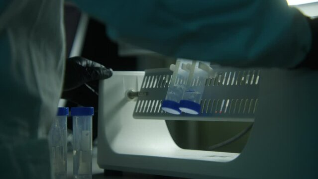 Tests in the laboratory. Stock footage. Young medical workers who work with equipment and assays in test tubes.