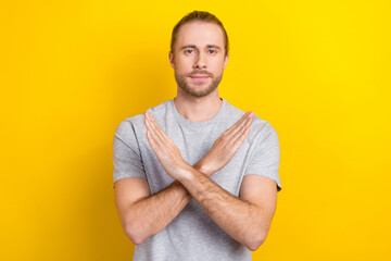 Photo of confident cool man wear grey t-shirt arms crossed showing no isolated yellow color...