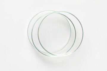Three empty Petri dishes on a light background.