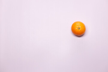 A ball of orange with a light bulb symbol on a lilac background.