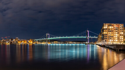  Gothenburg Midnight Skyline with Outlook over illuminated Alvsborgs Bridge reflecting in water of...