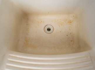 Stained and Dirty White Sink with Years of Neglect