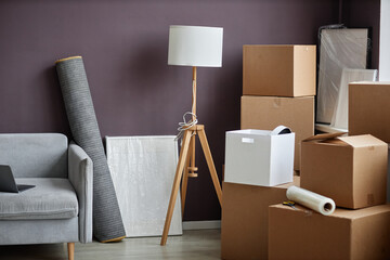 Horizontal image of packed cardboard boxes and furniture preparing for relocation