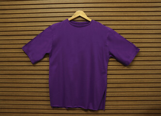 Purple empty t-shirt on wooden background