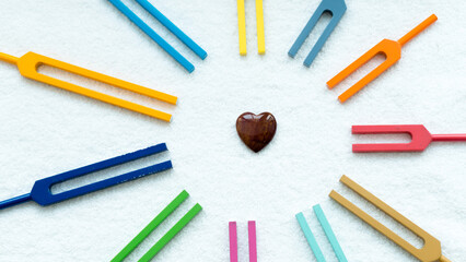 Set of colorful tuning forks like sun rays with heart symbol