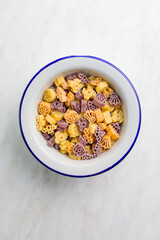 Pasta of various scary shapes. Uncooked halloween pasta in bowl. Top view.