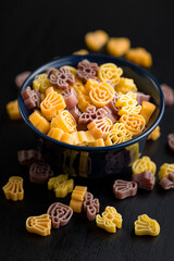 Pasta of various scary shapes. Uncooked halloween pasta in bowl.