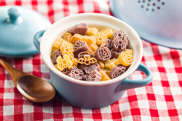 Pasta of various scary shapes. Uncooked halloween pasta in pot.