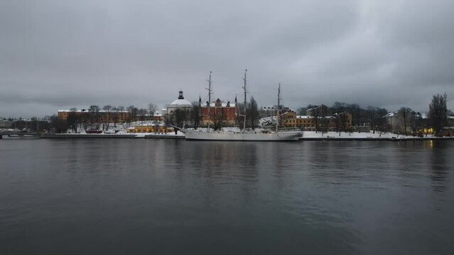 Aerial video of STF Af Chapman & Skeppsholmen Vandrarhem with a Persian ship in the background